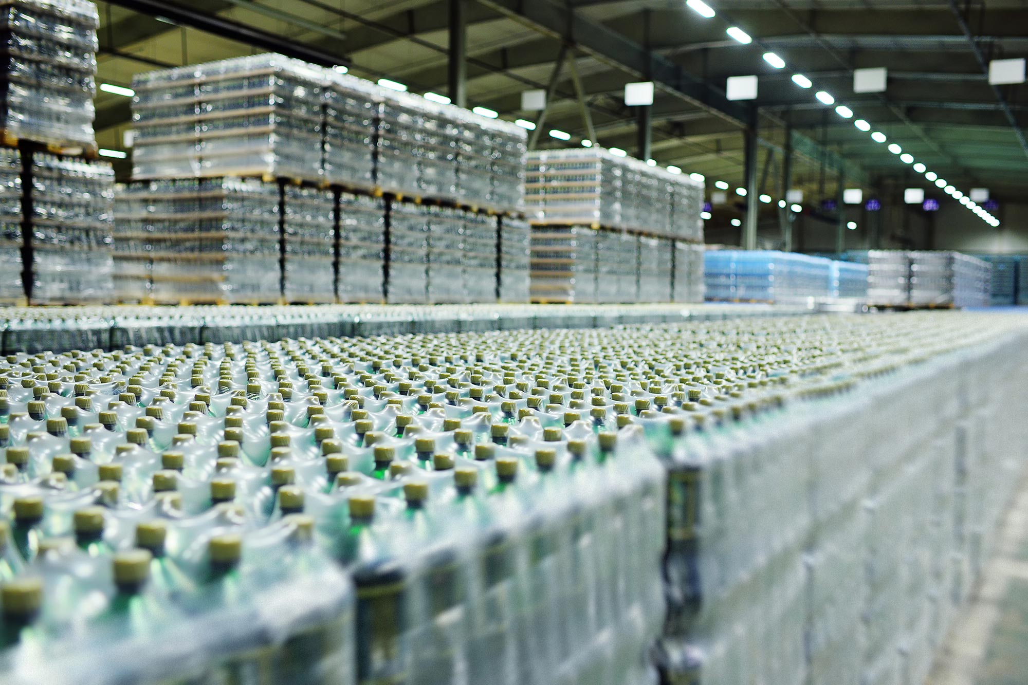 Huge industrial warehouse with plastic bottles in pallets