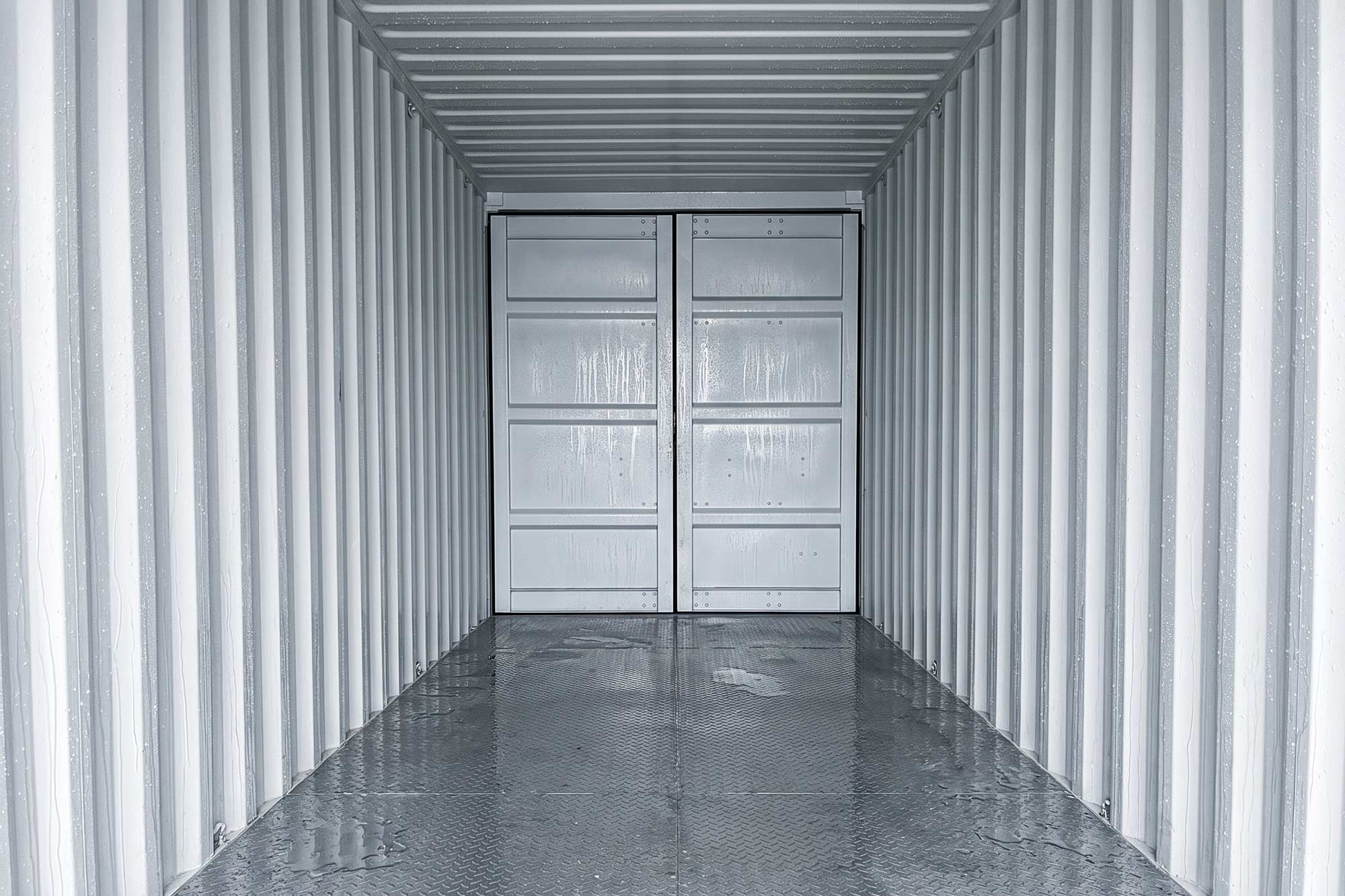 White shipping container with signs of container sweat